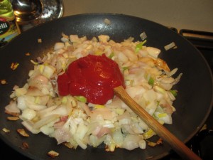 add tomato paste to onion